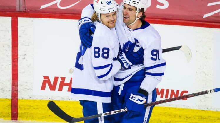 Apr 4, 2021; Calgary, Alberta, CAN; Toronto Maple Leafs center John Tavares (91) celebrates his goal with center William Nylander (88) during the third period against the Calgary Flames at Scotiabank Saddledome. Mandatory Credit: Sergei Belski-USA TODAY Sports