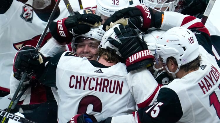 Apr 4, 2021; Anaheim, California, USA; Arizona Coyotes defenseman Jakob Chychrun (6) is mobbed by teammates after scoring the winning goal in overtime to beat the Anaheim Ducks 3-2 at Honda Center. It was Chychrun's third goal of the game. Mandatory Credit: Robert Hanashiro-USA TODAY Sports