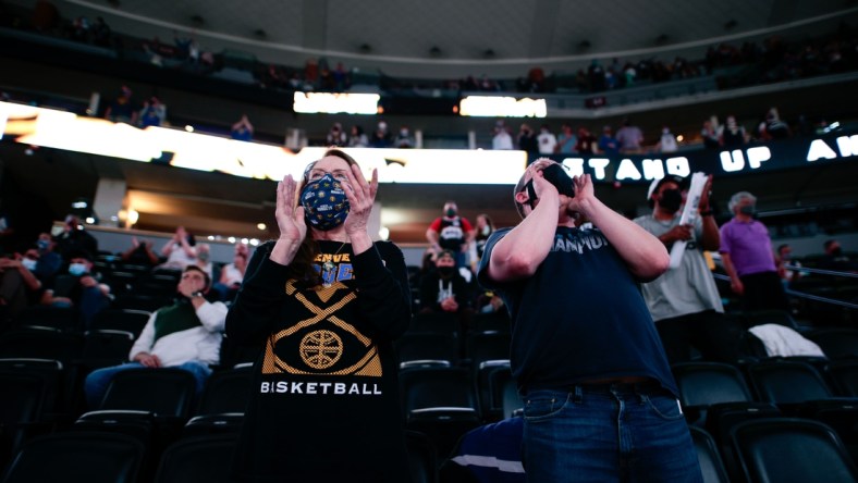 Apr 4, 2021; Denver, Colorado, USA; Denver Nuggets fans Vicki Ray (L) and Travis McDonnell (R) cheer in the fourth quarter of the game against the Orlando Magic at Ball Arena. Mandatory Credit: Isaiah J. Downing-USA TODAY Sports