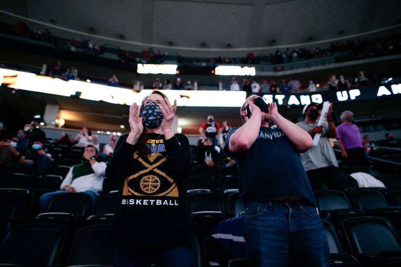 Apr 4, 2021; Denver, Colorado, USA; Denver Nuggets fans Vicki Ray (L) and Travis McDonnell (R) cheer in the fourth quarter of the game against the Orlando Magic at Ball Arena. Mandatory Credit: Isaiah J. Downing-USA TODAY Sports