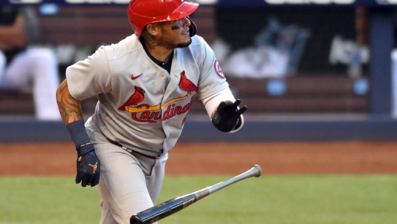 Apr 5, 2021; Miami, Florida, USA; St. Louis Cardinals catcher Yadier Molina (4) hits a double against the Miami Marlins in the first inning at loanDepot Park. Mandatory Credit: Jim Rassol-USA TODAY Sports