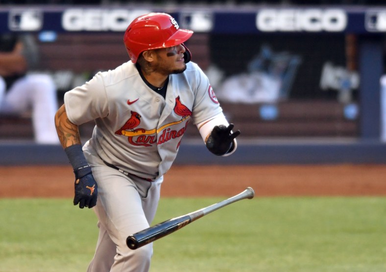Apr 5, 2021; Miami, Florida, USA; St. Louis Cardinals catcher Yadier Molina (4) hits a double against the Miami Marlins in the first inning at loanDepot Park. Mandatory Credit: Jim Rassol-USA TODAY Sports