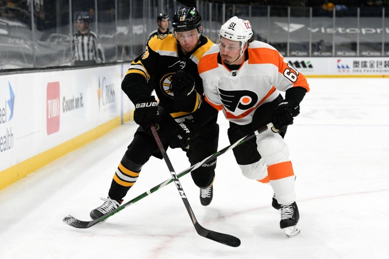 Apr 5, 2021; Boston, Massachusetts, USA; Boston Bruins center Charlie Coyle (13) and Philadelphia Flyers defenseman Justin Braun (61) compete for position during the first period at the TD Garden. Mandatory Credit: Brian Fluharty-USA TODAY Sports