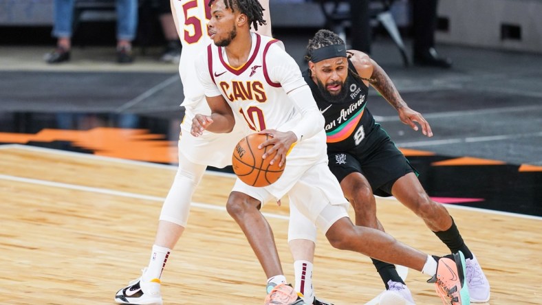 Apr 5, 2021; San Antonio, Texas, USA;  Cleveland Cavaliers guard Darius Garland (10) dribbles past San Antonio Spurs guard Patty Mills (8) in the first half at the AT&T Center. Mandatory Credit: Daniel Dunn-USA TODAY Sports