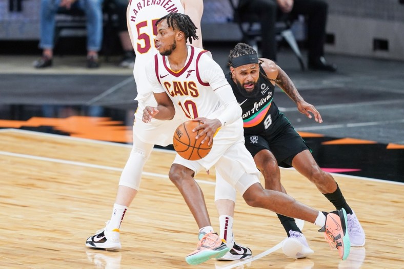 Apr 5, 2021; San Antonio, Texas, USA;  Cleveland Cavaliers guard Darius Garland (10) dribbles past San Antonio Spurs guard Patty Mills (8) in the first half at the AT&T Center. Mandatory Credit: Daniel Dunn-USA TODAY Sports