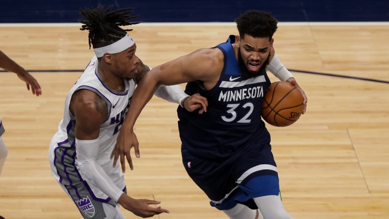 Apr 5, 2021; Minneapolis, Minnesota, USA; Minnesota Timberwolves center Karl-Anthony Towns (32) drives against Sacramento Kings center Richaun Holmes  (22) in the second quarter at Target Center. Mandatory Credit: Brad Rempel-USA TODAY Sports