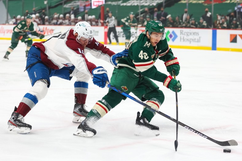 Apr 5, 2021; Saint Paul, Minnesota, USA; Colorado Avalanche right wing Valeri Nichushkin (13) and Minnesota Wild defenseman Jared Spurgeon (46) fight for the puck during the first period at Xcel Energy Center. Mandatory Credit: Harrison Barden-USA TODAY Sports