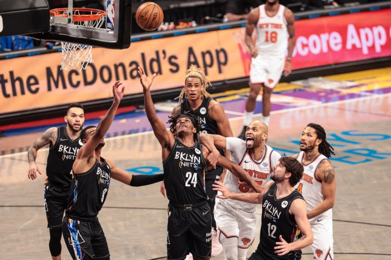 Apr 5, 2021; Brooklyn, New York, USA; Brooklyn Nets forward Alize Johnson (24) and guard Timothe Luwawu-Cabarrot (9) rebounds against New York Knicks center Taj Gibson (67) during the second half at Barclays Center. Mandatory Credit: Vincent Carchietta-USA TODAY Sports