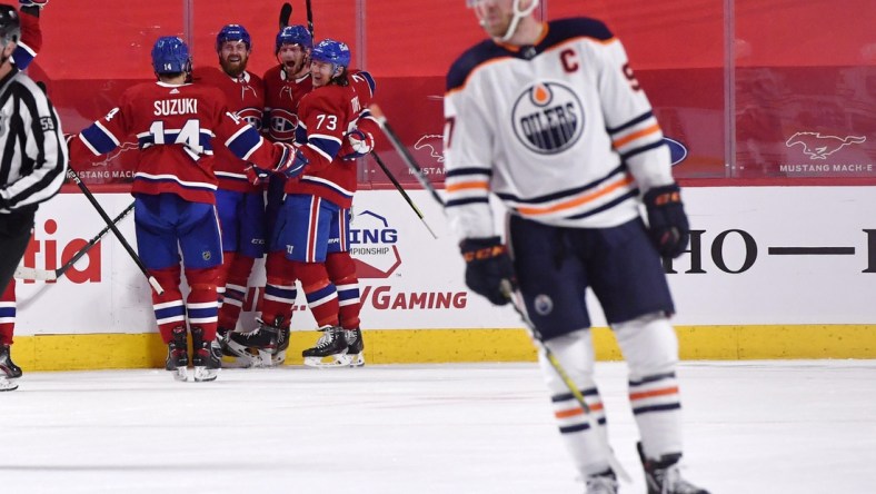 Apr 5, 2021; Montreal, Quebec, CAN; Montreal Canadiens forward Eric Staal (21) reacts with teammates including defenseman Jeff Petry (26) and forward Tyler Toffoli (73) and forward Nick Suzuki (14) after scoring the winning goal against the Edmonton Oilers during the overtime period at the Bell Centre. Mandatory Credit: Eric Bolte-USA TODAY Sports