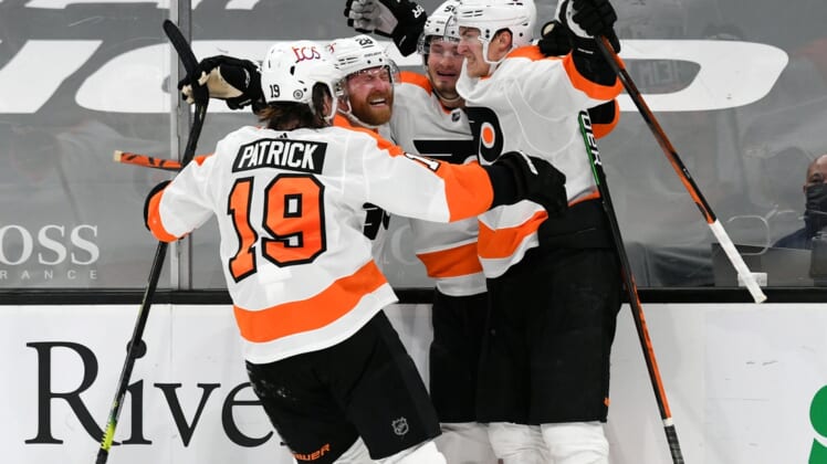 Apr 5, 2021; Boston, Massachusetts, USA; Philadelphia Flyers defenseman Travis Sanheim (6) celebrates with his teammates after scoring against the Boston Bruins during an overtime period at the TD Garden. Mandatory Credit: Brian Fluharty-USA TODAY Sports