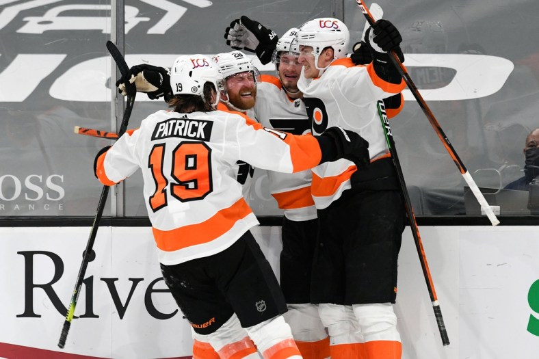 Apr 5, 2021; Boston, Massachusetts, USA; Philadelphia Flyers defenseman Travis Sanheim (6) celebrates with his teammates after scoring against the Boston Bruins during an overtime period at the TD Garden. Mandatory Credit: Brian Fluharty-USA TODAY Sports