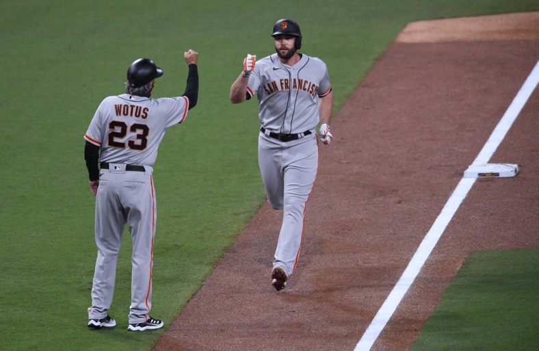 Apr 5, 2021; San Diego, California, USA; San Francisco Giants left fielder Darin Ruf (R) is congratulated by third base coach Ron Wotus (23) after hitting a home run against the San Diego Padres during the second inning at Petco Park. Mandatory Credit: Orlando Ramirez-USA TODAY Sports