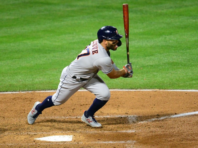 Apr 5, 2021; Anaheim, California, USA; Houston Astros second baseman Jose Altuve (27) hits an RBI single against the Los Angeles Angels during the fourth inning  at Angel Stadium. Mandatory Credit: Gary A. Vasquez-USA TODAY Sports
