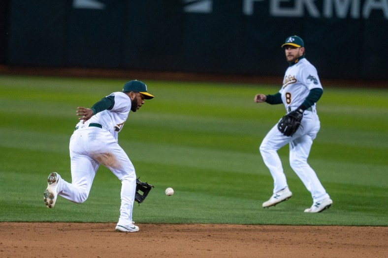 Apr 5, 2021; Oakland, California, USA; Oakland Athletics shortstop Elvis Andrus (17) fields a ground ball against the Los Angeles Dodgers during the ninth inning at RingCentral Coliseum. Mandatory Credit: Neville E. Guard-USA TODAY Sports
