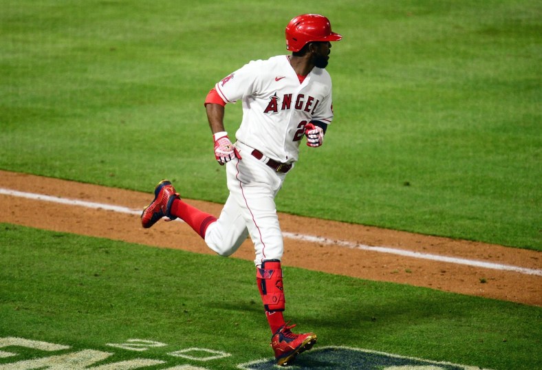 Apr 5, 2021; Anaheim, California, USA; Los Angeles Angels right fielder Dexter Fowler (25) hits an RBI single against the Houston Astros during the eighth inning at Angel Stadium. Mandatory Credit: Gary A. Vasquez-USA TODAY Sports