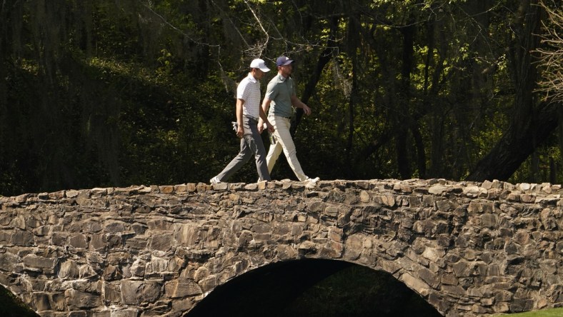 Apr 6, 2021; Augusta, Georgia, USA; Jordan Spieth and Daniel Berger walk on the Nelson Bridge on the 13th hole during a practice round for The Masters golf tournament at Augusta National Golf Club. Mandatory Credit: Rob Schumacher-USA TODAY Sports