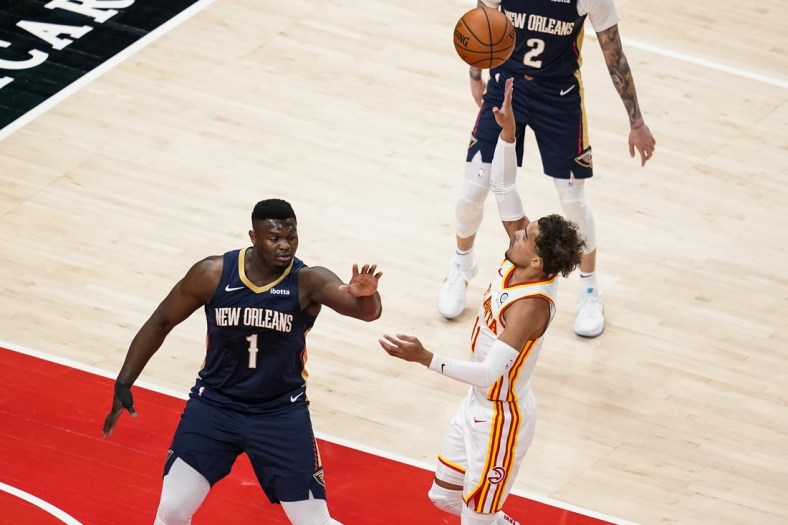 Apr 6, 2021; Atlanta, Georgia, USA; Atlanta Hawks guard Trae Young (11) shoots over New Orleans Pelicans forward Zion Williamson (1) during the first quarter at State Farm Arena. Mandatory Credit: Dale Zanine-USA TODAY Sports
