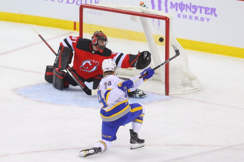 Apr 6, 2021; Newark, New Jersey, USA; Buffalo Sabres center Rasmus Asplund (74) scores a goal on New Jersey Devils goaltender Scott Wedgewood (41) during the first period at Prudential Center. Mandatory Credit: Ed Mulholland-USA TODAY Sports