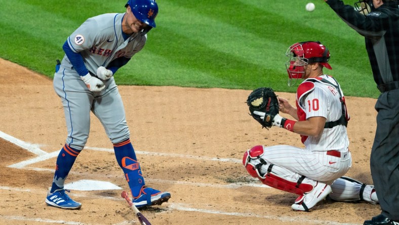 Apr 6, 2021; Philadelphia, Pennsylvania, USA; The New York Mets' J.D. Davis (28) reacts in front of Philadelphia Phillies catcher J.T. Realmuto (10) after being hit by a pitch during the first inning at Citizens Bank Park. Mandatory Credit: Bill Streicher-USA TODAY Sports