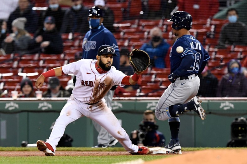 Apr 6, 2021; Boston, Massachusetts, USA; Tampa Bay Rays catcher Francisco Mejia (28) is safe at first base in front of Boston Red Sox first baseman Marwin Gonzalez (12) during the fourth inning at Fenway Park. Mandatory Credit: Brian Fluharty-USA TODAY Sports