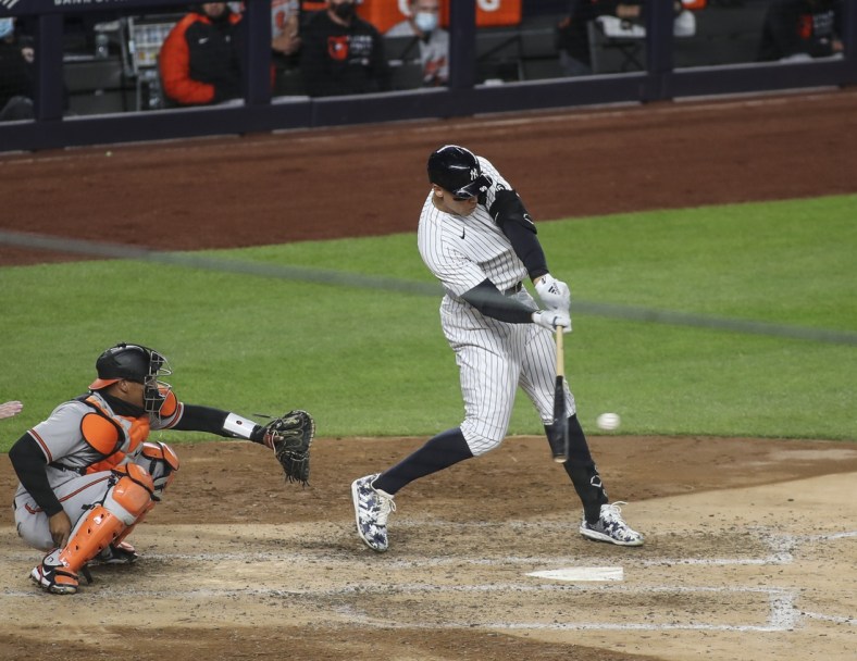 Apr 6, 2021; Bronx, New York, USA; New York Yankees right fielder Aaron Judge (99) hits an RBI single in the fourth inning against the Baltimore Orioles at Yankee Stadium. Mandatory Credit: Wendell Cruz-USA TODAY Sports