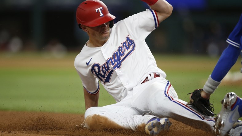 Apr 6, 2021; Arlington, Texas, USA; Texas Rangers second baseman Nick Solak (15) steals third base against Toronto Blue Jays third baseman Cavan Biggio (8) in the third inning at Globe Life Field. Mandatory Credit: Tim Heitman-USA TODAY Sports