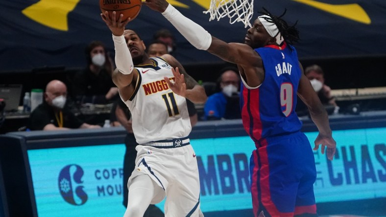 Apr 6, 2021; Denver, Colorado, USA; Detroit Pistons forward Jerami Grant (9) tips the ball from 
Denver Nuggets guard Monte Morris (11) in the first quarter at Ball Arena. Mandatory Credit: Ron Chenoy-USA TODAY Sports