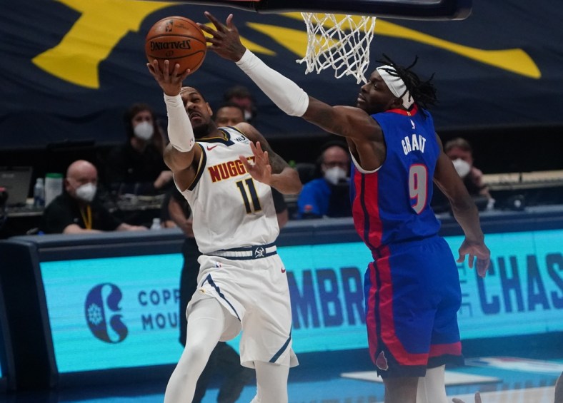 Apr 6, 2021; Denver, Colorado, USA; Detroit Pistons forward Jerami Grant (9) tips the ball from 
Denver Nuggets guard Monte Morris (11) in the first quarter at Ball Arena. Mandatory Credit: Ron Chenoy-USA TODAY Sports
