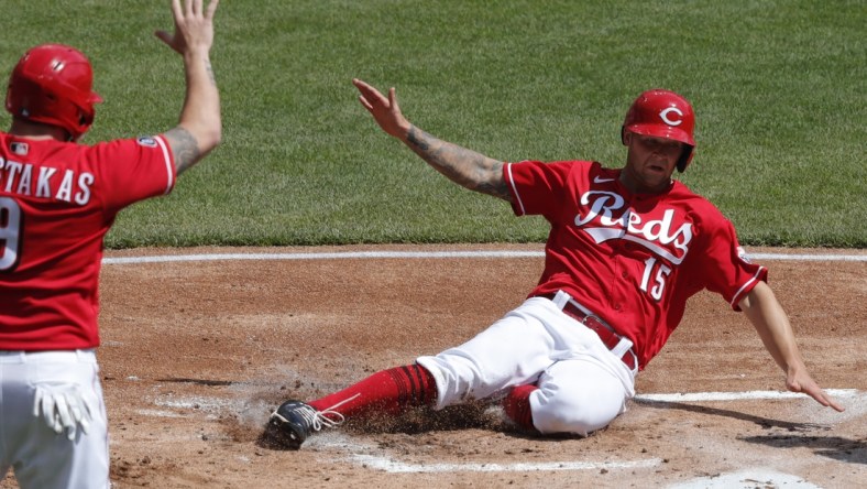 Apr 7, 2021; Cincinnati, Ohio, USA; Cincinnati Reds center fielder Nick Senzel (15) scores against the Pittsburgh Pirates during the first inning at Great American Ball Park. Mandatory Credit: David Kohl-USA TODAY Sports