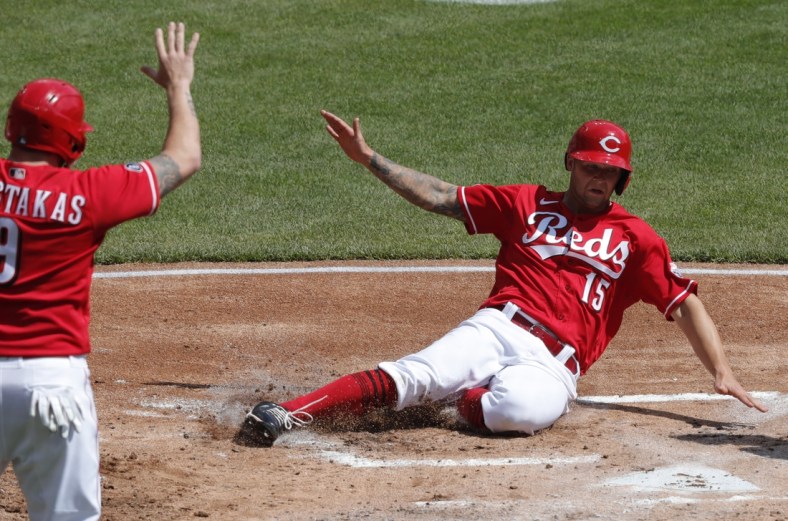 Apr 7, 2021; Cincinnati, Ohio, USA; Cincinnati Reds center fielder Nick Senzel (15) scores against the Pittsburgh Pirates during the first inning at Great American Ball Park. Mandatory Credit: David Kohl-USA TODAY Sports