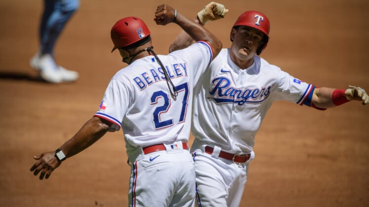 Apr 7, 2021; Arlington, Texas, USA; Texas Rangers third base coach Tony Beasley (27) and second baseman Nick Solak (15)  celebrate Solak hitting a home run against the Toronto Blue Jays  during the second inning at Globe Life Field. Mandatory Credit: Jerome Miron-USA TODAY Sports