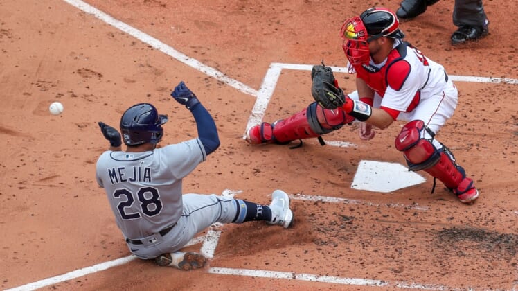 Apr 7, 2021; Boston, Massachusetts, USA; Tampa Bay Rays catcher Francisco Mejia (28) beats the throw home to Boston Red Sox catcher Kevin Plawecki (25) during the third inning at Fenway Park. Mandatory Credit: Paul Rutherford-USA TODAY Sports