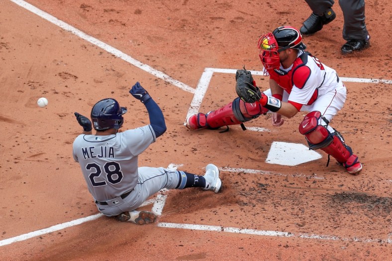 Apr 7, 2021; Boston, Massachusetts, USA; Tampa Bay Rays catcher Francisco Mejia (28) beats the throw home to Boston Red Sox catcher Kevin Plawecki (25) during the third inning at Fenway Park. Mandatory Credit: Paul Rutherford-USA TODAY Sports