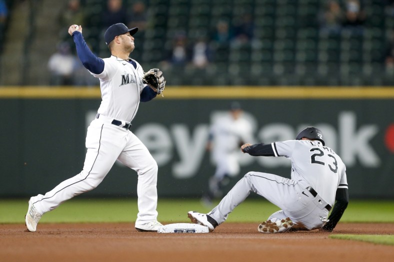 Apr 7, 2021; Seattle, Washington, USA; Seattle Mariners second baseman Ty France (23) attempts to turn a double play against Chicago White Sox third baseman Jake Lamb (23) during the first inning at T-Mobile Park. Mandatory Credit: Joe Nicholson-USA TODAY Sports