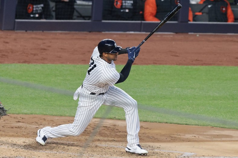 Apr 7, 2021; Bronx, New York, USA; New York Yankees center fielder Aaron Hicks (31) hits an RBI single during the third inning against the Baltimore Orioles at Yankee Stadium. Mandatory Credit: Vincent Carchietta-USA TODAY Sports