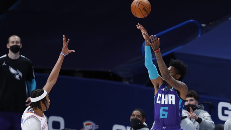 Apr 7, 2021; Oklahoma City, Oklahoma, USA; Charlotte Hornets forward Jalen McDaniels (6) shoots a three point basket over Oklahoma City Thunder center Moses Brown (9) during the first quarter at Chesapeake Energy Arena. Mandatory Credit: Alonzo Adams-USA TODAY Sports