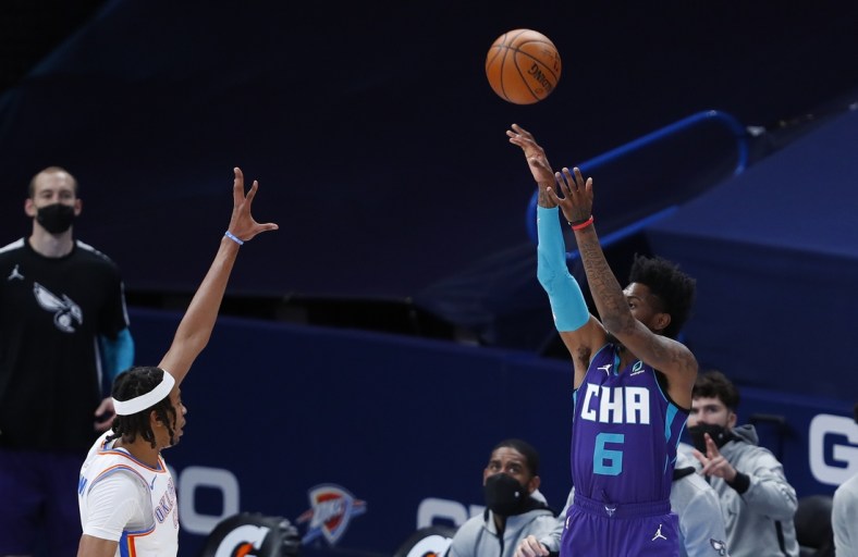 Apr 7, 2021; Oklahoma City, Oklahoma, USA; Charlotte Hornets forward Jalen McDaniels (6) shoots a three point basket over Oklahoma City Thunder center Moses Brown (9) during the first quarter at Chesapeake Energy Arena. Mandatory Credit: Alonzo Adams-USA TODAY Sports