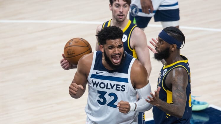 Apr 7, 2021; Indianapolis, Indiana, USA; Minnesota Timberwolves center Karl-Anthony Towns (32) reacts to a foul in the third quarter against the Indiana Pacers at Bankers Life Fieldhouse. Mandatory Credit: Trevor Ruszkowski-USA TODAY Sports