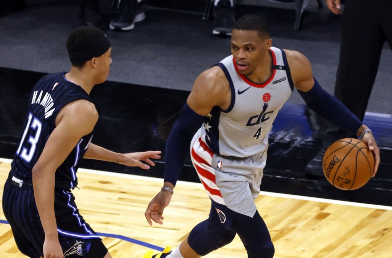 Apr 7, 2021; Orlando, Florida, USA; Washington Wizards guard Russell Westbrook (4) drives to the basket as Orlando Magic guard R.J. Hampton (13) defends during the second half at Amway Center. Mandatory Credit: Kim Klement-USA TODAY Sports