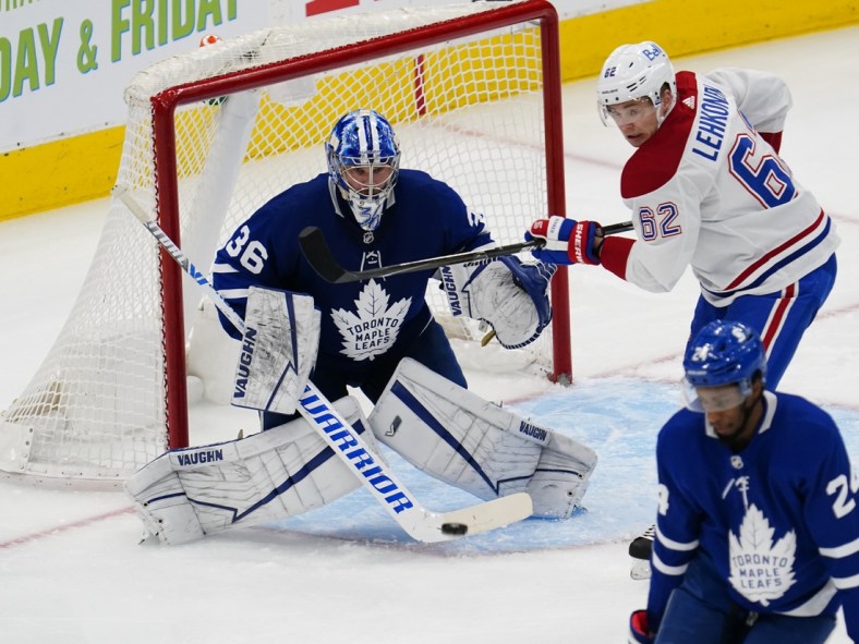 Apr 7, 2021; Toronto, Ontario, CAN; Montreal Canadiens forward Artturi Lehkonen (62) tries to deflect a shot against Toronto Maple Leafs goaltender Jack Campbell (36) during the second period at Scotiabank Arena. Mandatory Credit: John E. Sokolowski-USA TODAY Sports