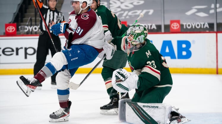 Apr 7, 2021; Saint Paul, Minnesota, USA;  Colorado Avalanche forward Nazem Kadri (91) is cross checked in front of Minnesota Wild goalie Cam Talbot (33) in the first period at Xcel Energy Center. Mandatory Credit: Brad Rempel-USA TODAY Sports