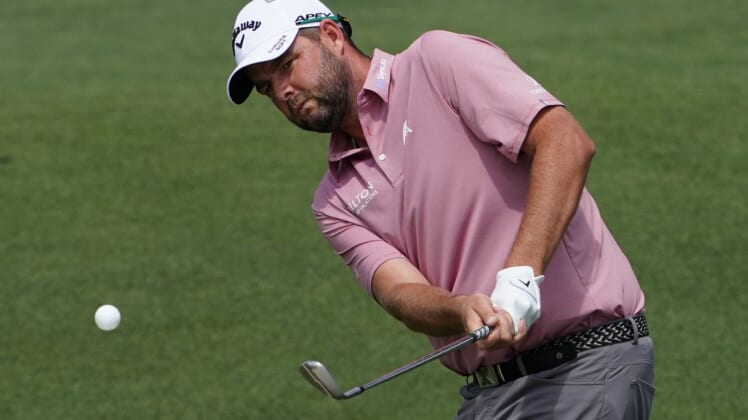 Apr 8, 2021; Augusta, Georgia, USA; Marc Leishman chips onto the 2nd green during the first round of The Masters golf tournament. Mandatory Credit: Michael Madrid-USA TODAY Sports