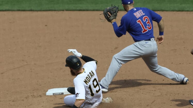 Apr 8, 2021; Pittsburgh, Pennsylvania, USA;  Pittsburgh Pirates third baseman Colin Moran (19) slides into second base with a double as Chicago Cubs second baseman David Bote (13) takes a throw during the fifth inning at PNC Park. Mandatory Credit: Charles LeClaire-USA TODAY Sports