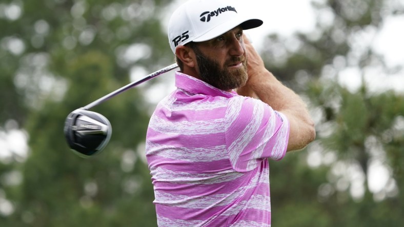 Apr 8, 2021; Augusta, Georgia, USA; Dustin Johnson hits his tee shot on the 18th hole during the first round of The Masters golf tournament. Mandatory Credit: Michael Madrid-USA TODAY Sports