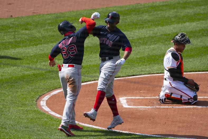 Apr 8, 2021; Baltimore, Maryland, USA;  Boston Red Sox third baseman Rafael Devers (11) celebrates with Boston Red Sox center fielder Alex Verdugo (99) at home plate after hitting a two run home run during the first inning as Baltimore Orioles catcher Pedro Severino (28) looks on at Oriole Park at Camden Yards. Mandatory Credit: Tommy Gilligan-USA TODAY Sports