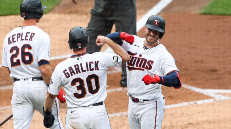 Apr 8, 2021; Minneapolis, Minnesota, USA; Minnesota Twins left fielder Kyle Garlick (30) celebrates with catcher Mitch Garver (8) after Garver hit a three-run home run in the third inning against the Seattle Mariners at Target Field. Mandatory Credit: David Berding-USA TODAY Sports