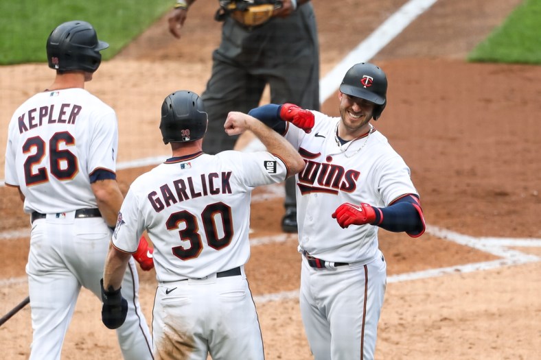 Apr 8, 2021; Minneapolis, Minnesota, USA; Minnesota Twins left fielder Kyle Garlick (30) celebrates with catcher Mitch Garver (8) after Garver hit a three-run home run in the third inning against the Seattle Mariners at Target Field. Mandatory Credit: David Berding-USA TODAY Sports