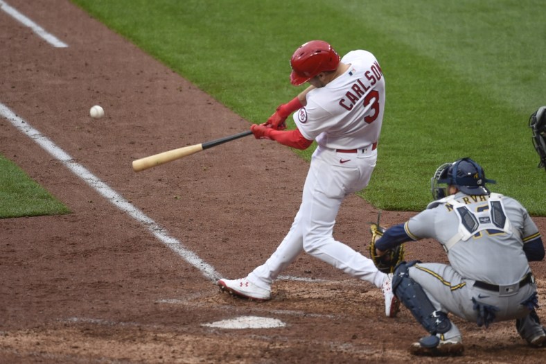 Apr 8, 2021; St. Louis, Missouri, USA; St. Louis Cardinals center fielder Dylan Carlson (3) hits a double against the Milwaukee Brewers in the seventh inning at Busch Stadium. Mandatory Credit: Joe Puetz-USA TODAY Sports