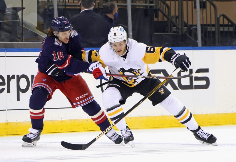 Apr 8, 2021; New York, New York, USA; Pittsburgh Penguins defenseman John Marino (6) plays for the puck against New York Rangers left wing Artemi Panarin (10) during the first period at Madison Square Garden. Mandatory Credit:  Bruce Bennett/Pool Photo-USA TODAY Sports