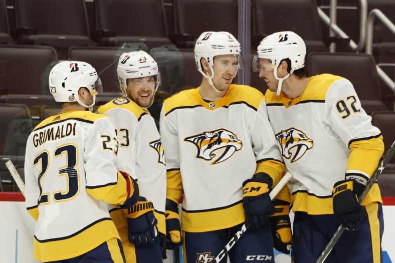 Apr 8, 2021; Detroit, Michigan, USA;  Nashville Predators right wing Viktor Arvidsson (33) is congratulated by teammates after scoring in the third period against the Detroit Red Wings at Little Caesars Arena. Mandatory Credit: Rick Osentoski-USA TODAY Sports